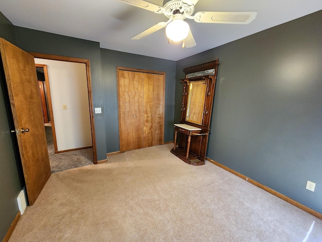 5206 Wolf Ln, Farwell, MI 48622 - unfurnished bedroom with carpet floors, a closet, baseboards, and ceiling fan