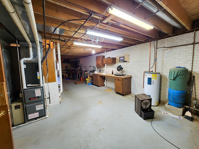 5206 Wolf Ln, Farwell, MI 48622 - unfinished below grade area with electric water heater, a workshop area, and brick wall