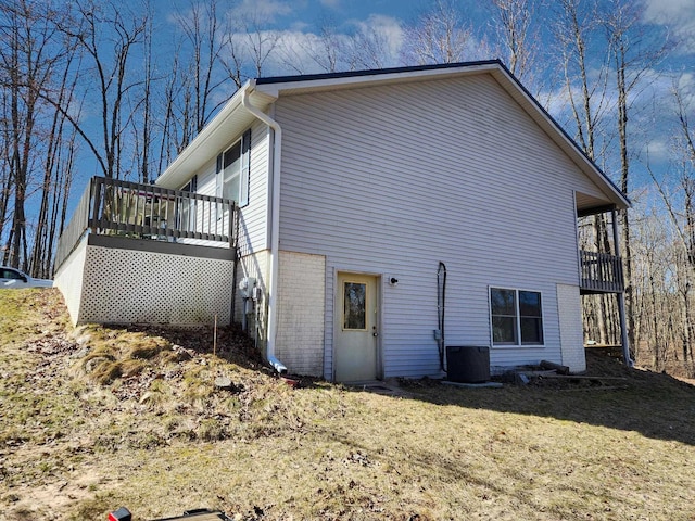5206 Wolf Ln, Farwell, MI 48622 - view of property exterior featuring cooling unit, a deck, a yard, and brick siding