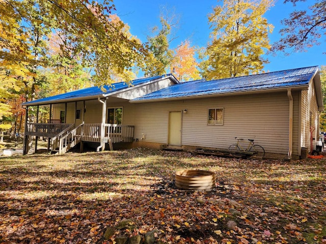 back of house featuring covered porch