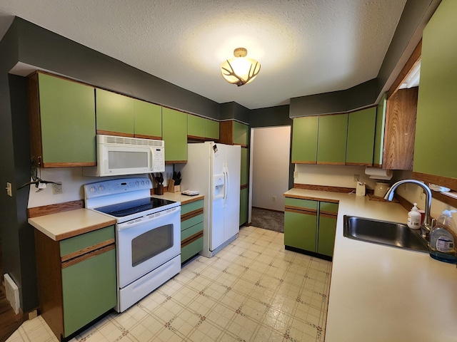 5206 Wolf Ln, Farwell, MI 48622 - kitchen featuring white appliances, a sink, light flooring, green cabinetry, and a textured ceiling