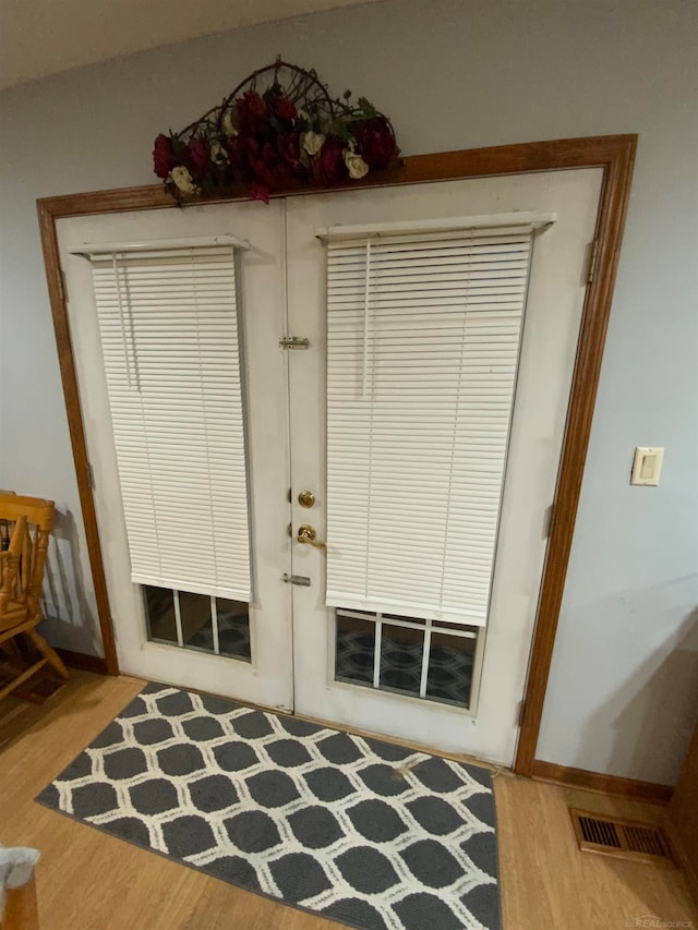 interior space with french doors and wood-type flooring