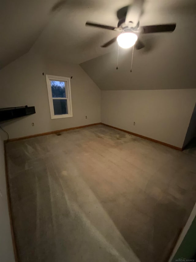 additional living space with lofted ceiling, carpet, and ceiling fan