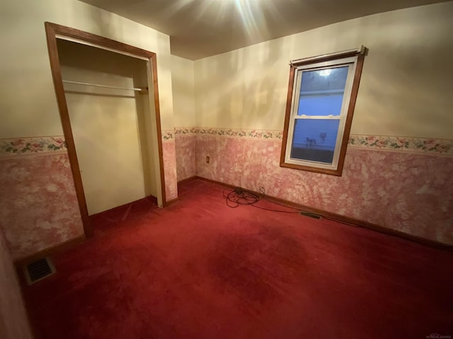 unfurnished bedroom with carpet floors and a closet