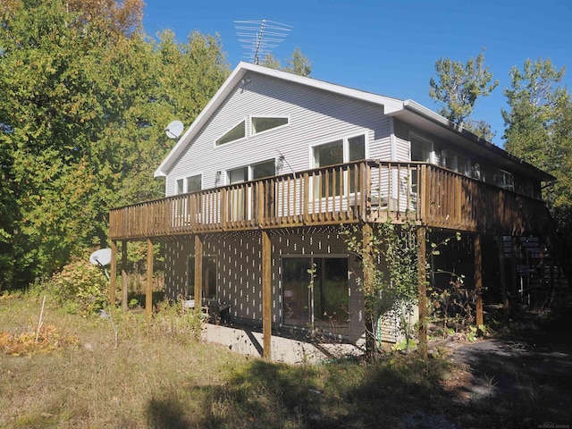 back of property featuring a wooden deck