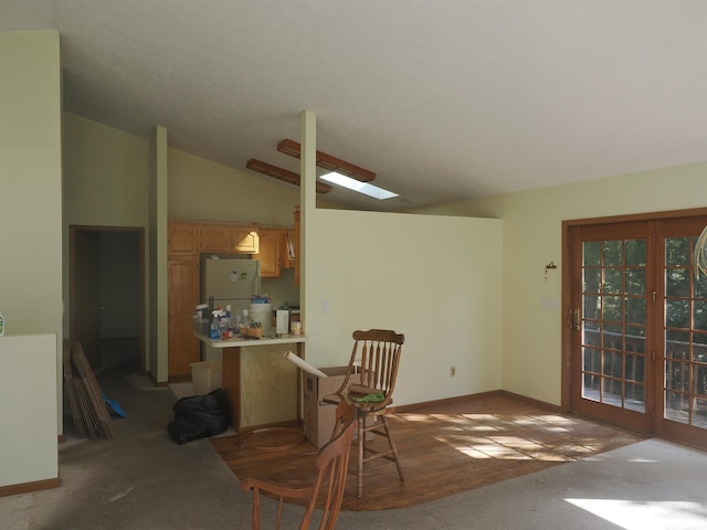 interior space featuring vaulted ceiling and carpet flooring