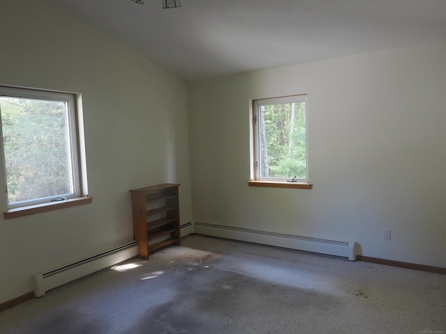 spare room featuring carpet flooring, lofted ceiling, and baseboard heating