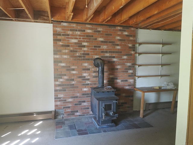 interior details with a baseboard radiator, concrete flooring, and a wood stove