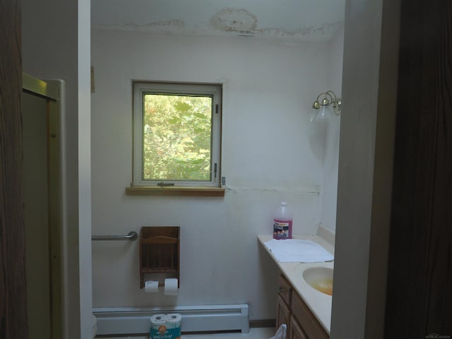 bathroom with vanity, a shower, and baseboard heating