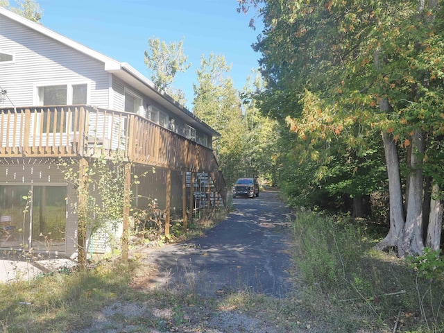 view of home's exterior with a wooden deck