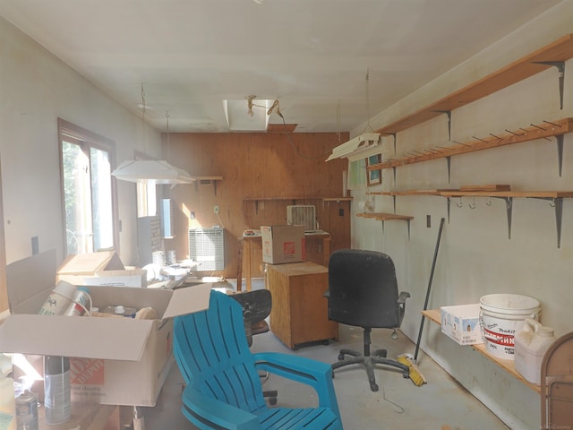 office featuring wooden walls and concrete flooring