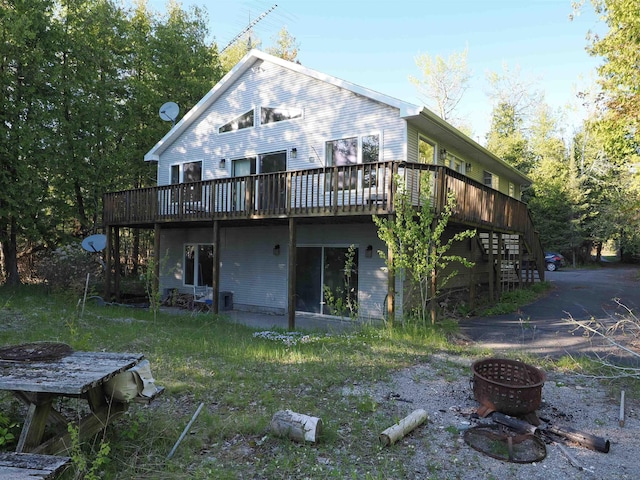 7502 Kauffman Blvd, Presque Isle, MI 49777 - back of house featuring a fire pit, a wooden deck, and stairway