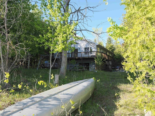 7502 Kauffman Blvd, Presque Isle, MI 49777 - rear view of house featuring a wooden deck and stairway