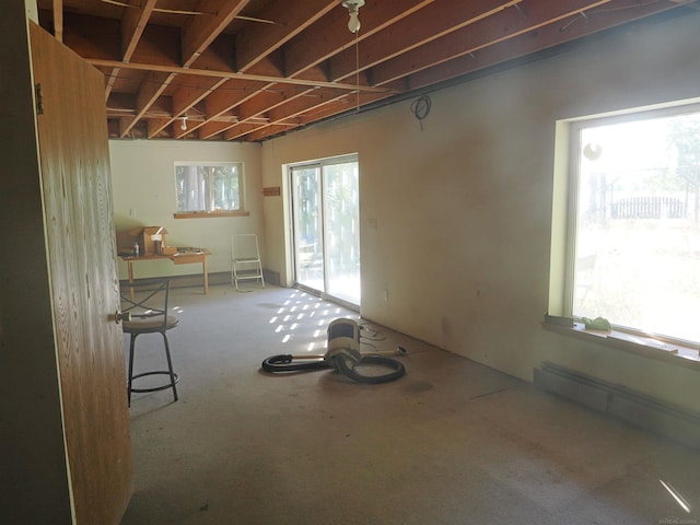 miscellaneous room featuring a wealth of natural light and a baseboard heating unit