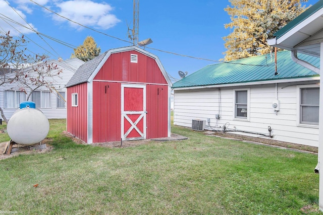 view of outbuilding with central AC and a lawn