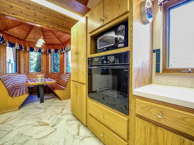 kitchen with black appliances, vaulted ceiling with beams, a healthy amount of sunlight, and wood ceiling