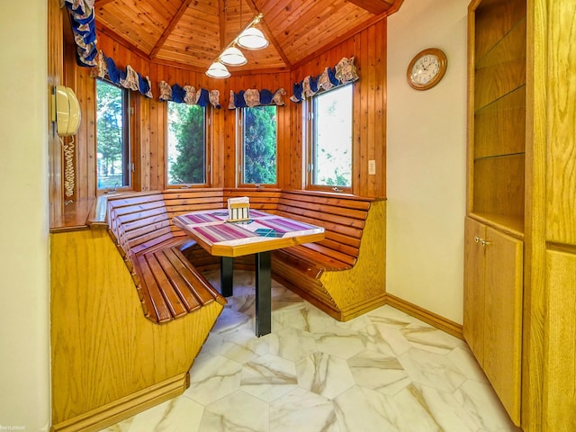 dining room featuring lofted ceiling, breakfast area, and wooden ceiling