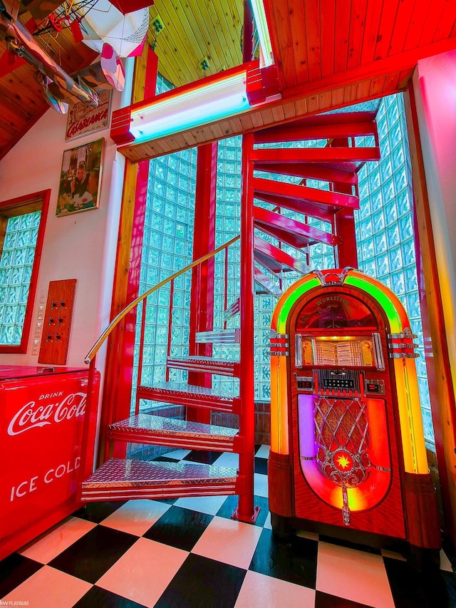 stairs with vaulted ceiling and wood ceiling