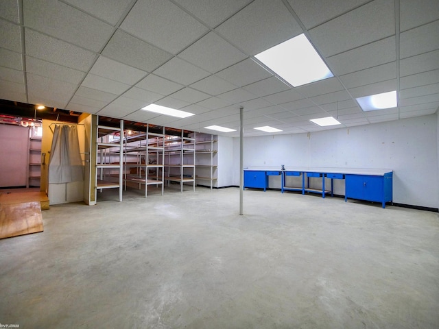 basement featuring a paneled ceiling