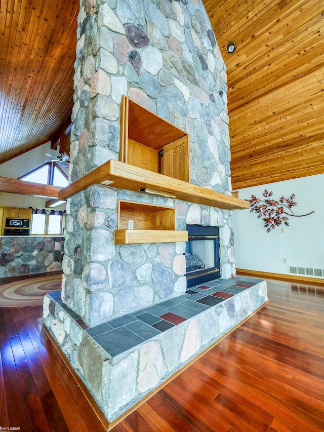 unfurnished living room featuring ceiling fan, a stone fireplace, high vaulted ceiling, hardwood / wood-style floors, and wood ceiling