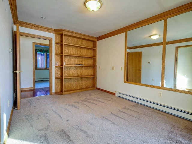 empty room with carpet flooring, ornamental molding, and a baseboard radiator