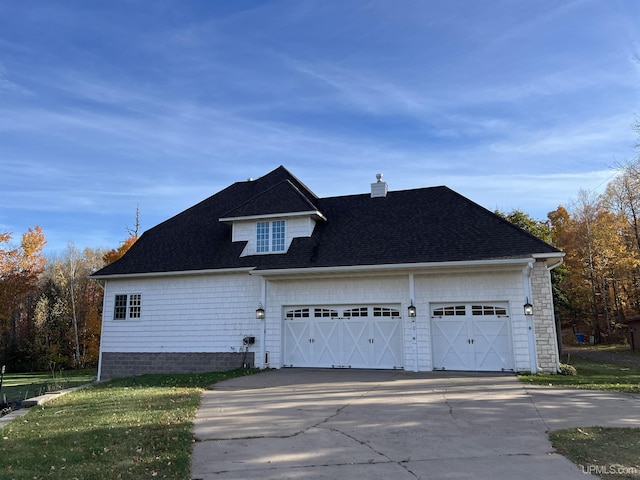 view of property exterior featuring concrete driveway, a chimney, roof with shingles, and a garage