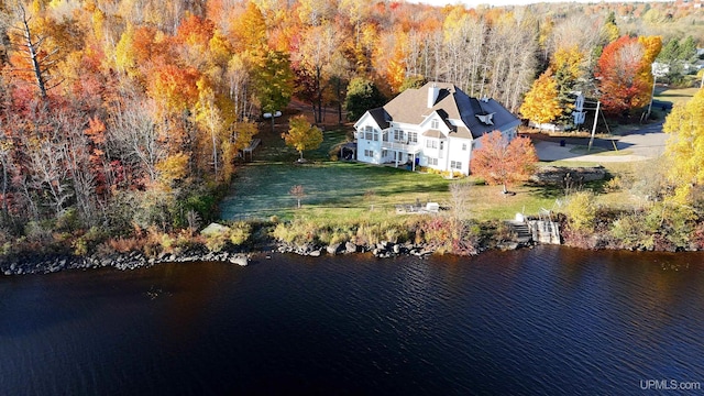 birds eye view of property with a forest view and a water view