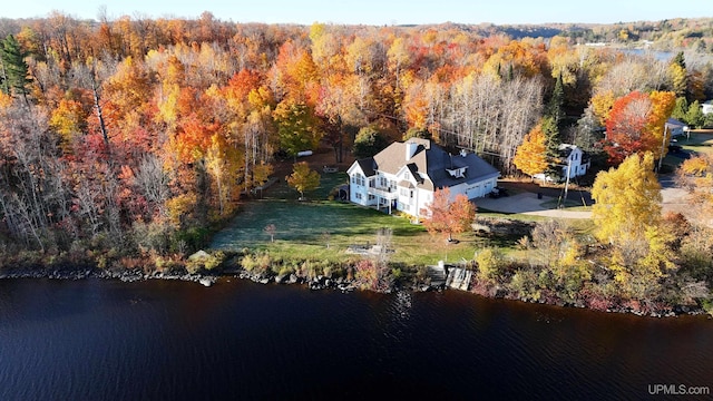 drone / aerial view featuring a view of trees and a water view