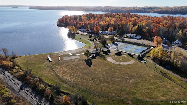 drone / aerial view with a view of trees and a water view