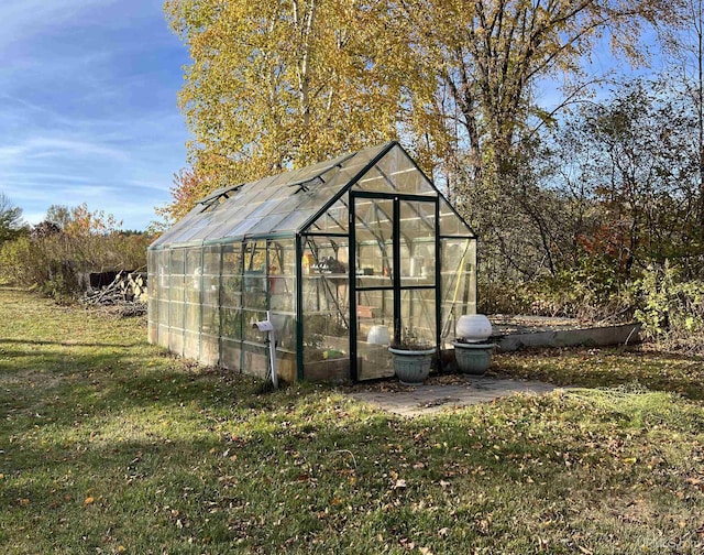 view of greenhouse featuring a lawn