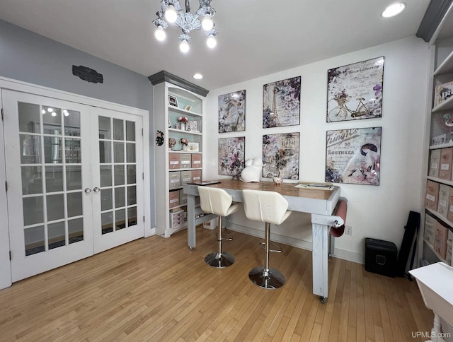 office space featuring wood-type flooring, baseboards, a notable chandelier, and french doors
