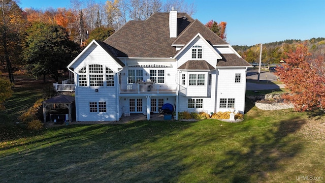 back of house with french doors, a patio area, and a lawn