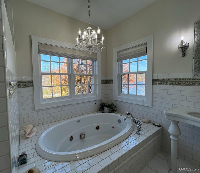 bathroom with tile walls, plenty of natural light, and tiled bath