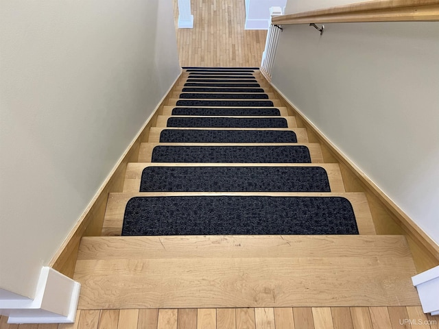 stairway featuring wood finished floors
