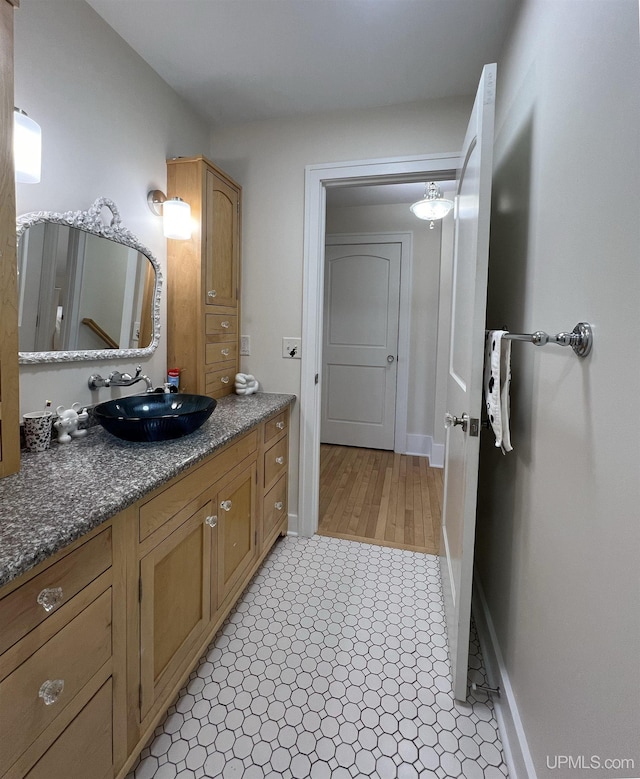 bathroom with vanity and baseboards