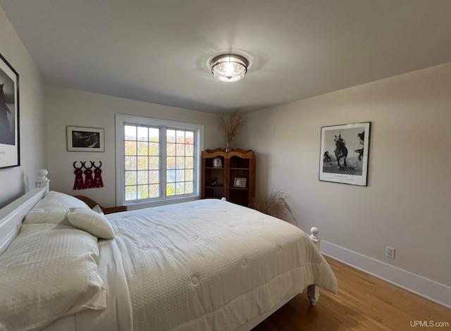 bedroom with hardwood / wood-style floors