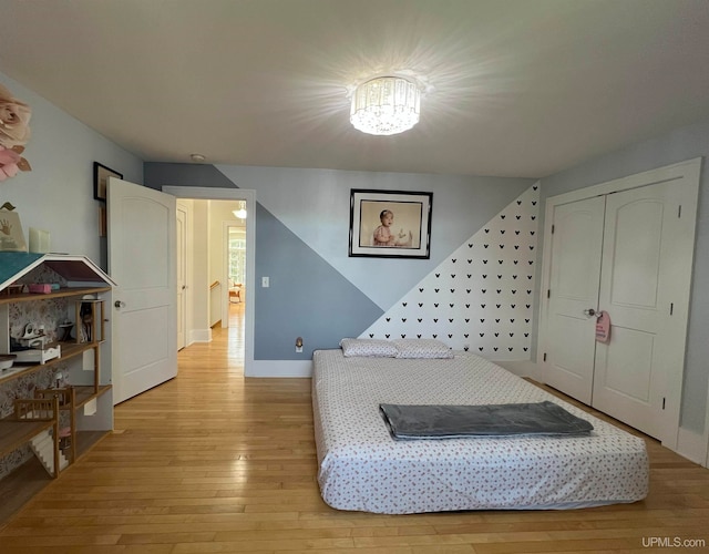 bedroom with a closet and light hardwood / wood-style floors