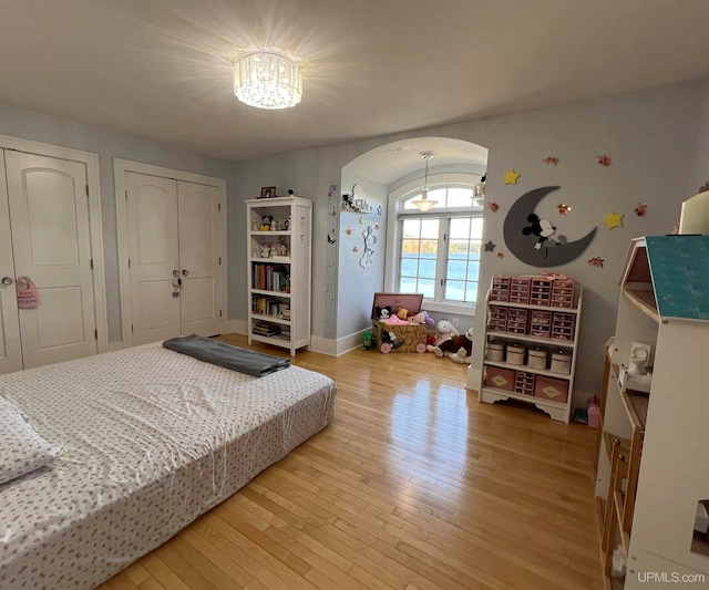 bedroom featuring french doors and hardwood / wood-style flooring