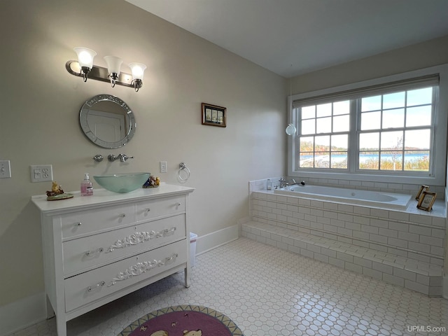 bathroom with vanity and a relaxing tiled tub