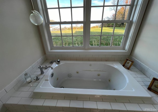 bathroom with plenty of natural light and tiled tub