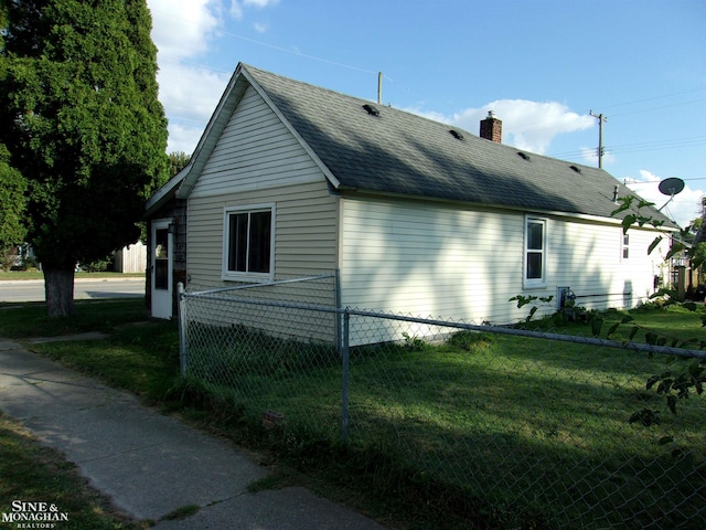 view of home's exterior with a yard