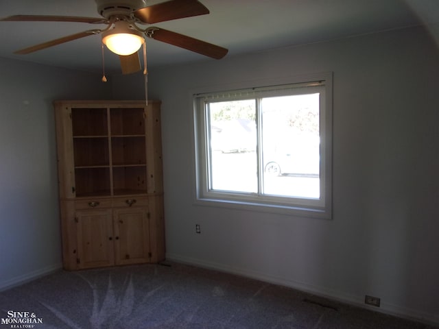 empty room with carpet flooring and ceiling fan