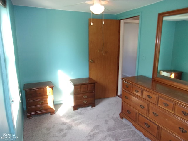 carpeted bedroom with a closet and ceiling fan