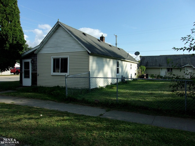 view of side of home featuring a lawn