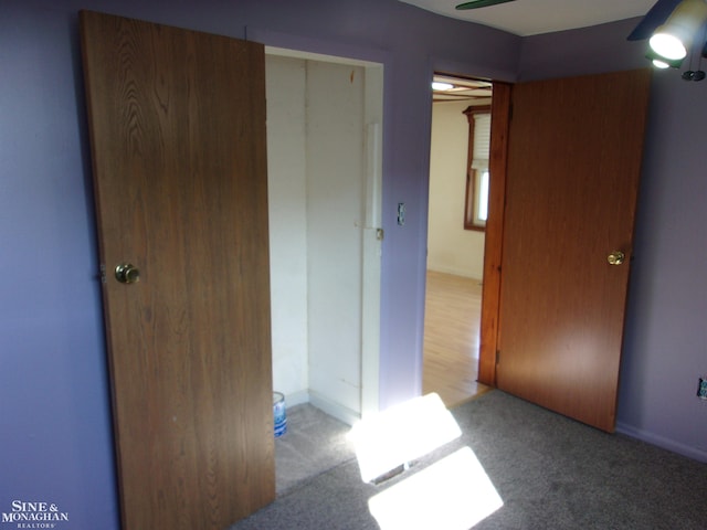 unfurnished bedroom with light carpet, a closet, and ceiling fan