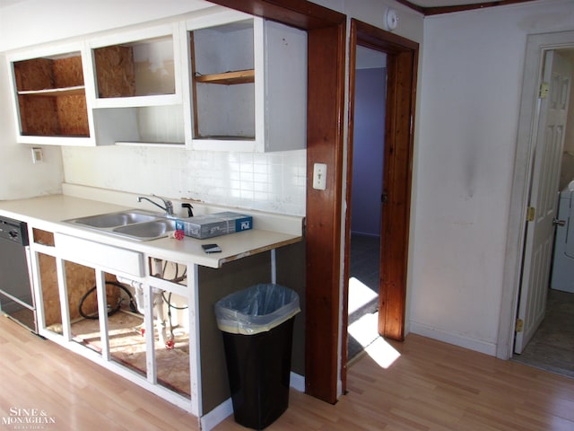 kitchen featuring washer / clothes dryer, sink, dishwasher, backsplash, and light hardwood / wood-style floors