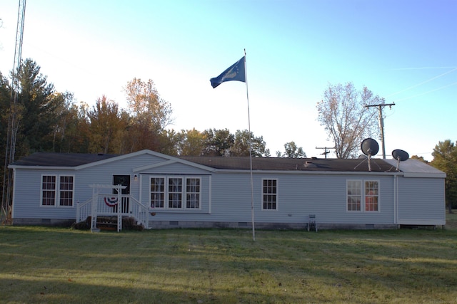 rear view of property with a lawn