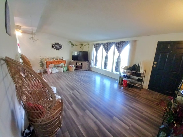 living room featuring an inviting chandelier and hardwood / wood-style floors