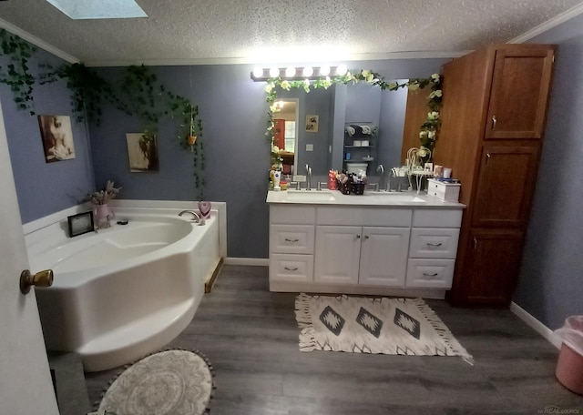 bathroom with vanity, a tub to relax in, ornamental molding, and hardwood / wood-style floors