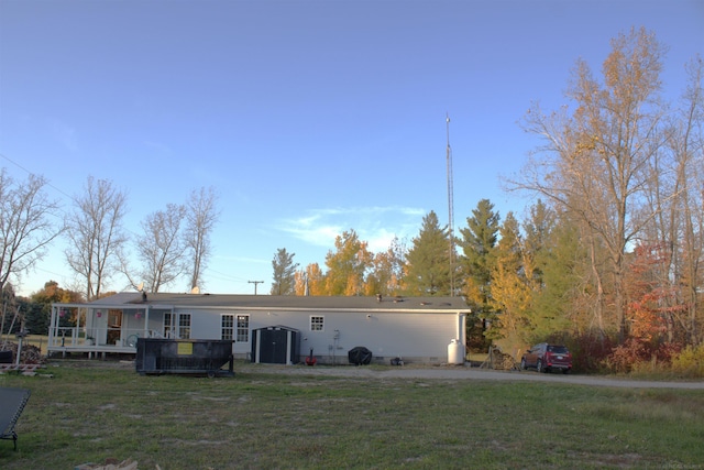 view of front of home with a front yard and a wooden deck